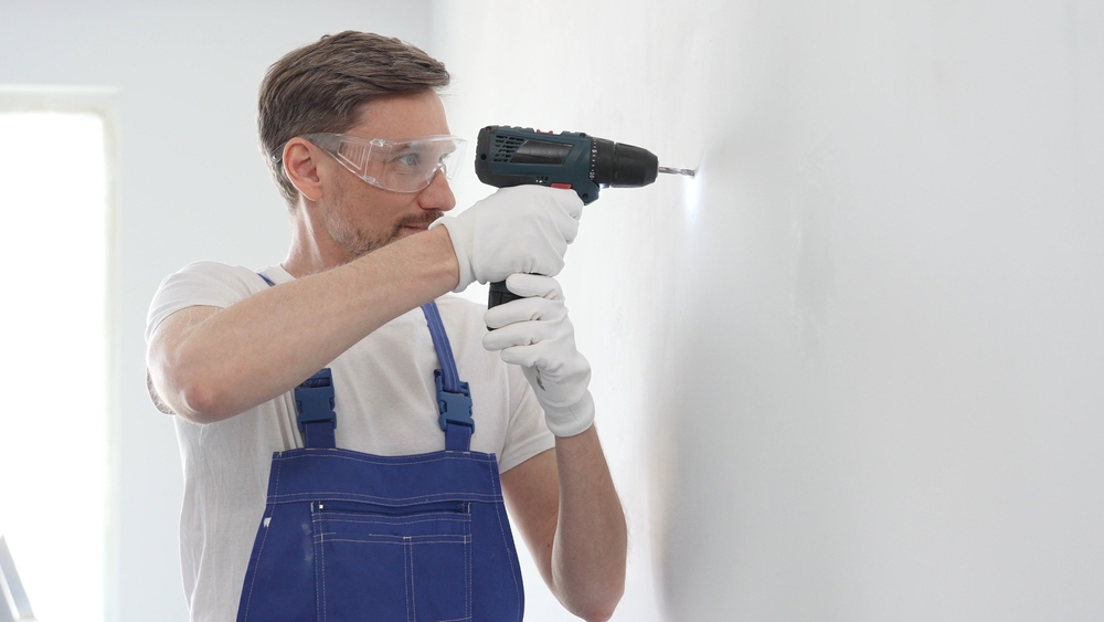 Middle,Aged,Man,Wearing,Blue,Overall,And,Protective,Glasses,,Is