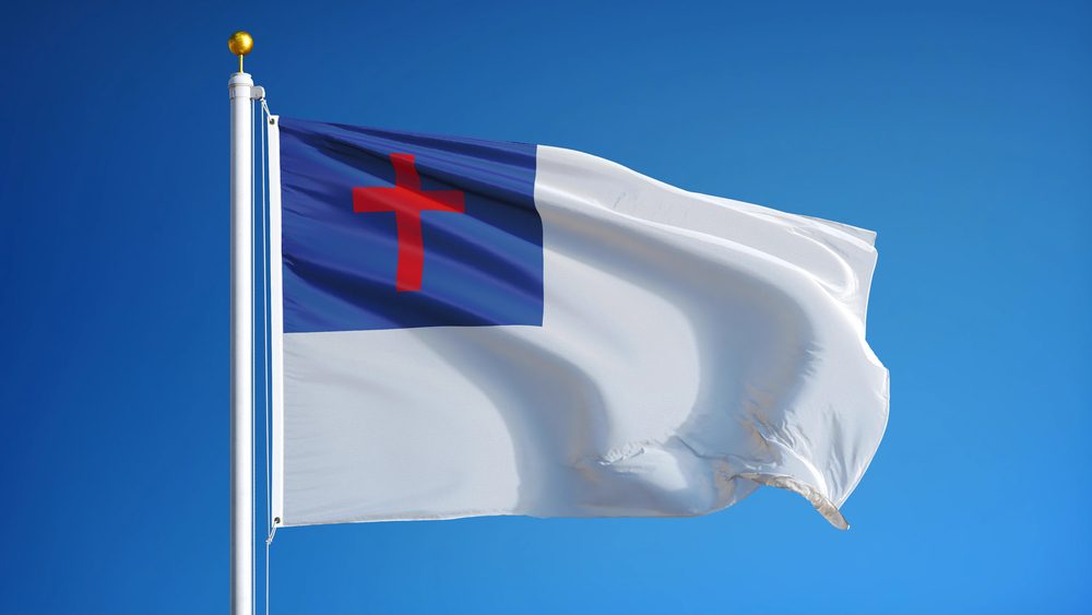 Christian,Flag,Waving,Against,Clean,Blue,Sky,,Close,Up,,Isolated