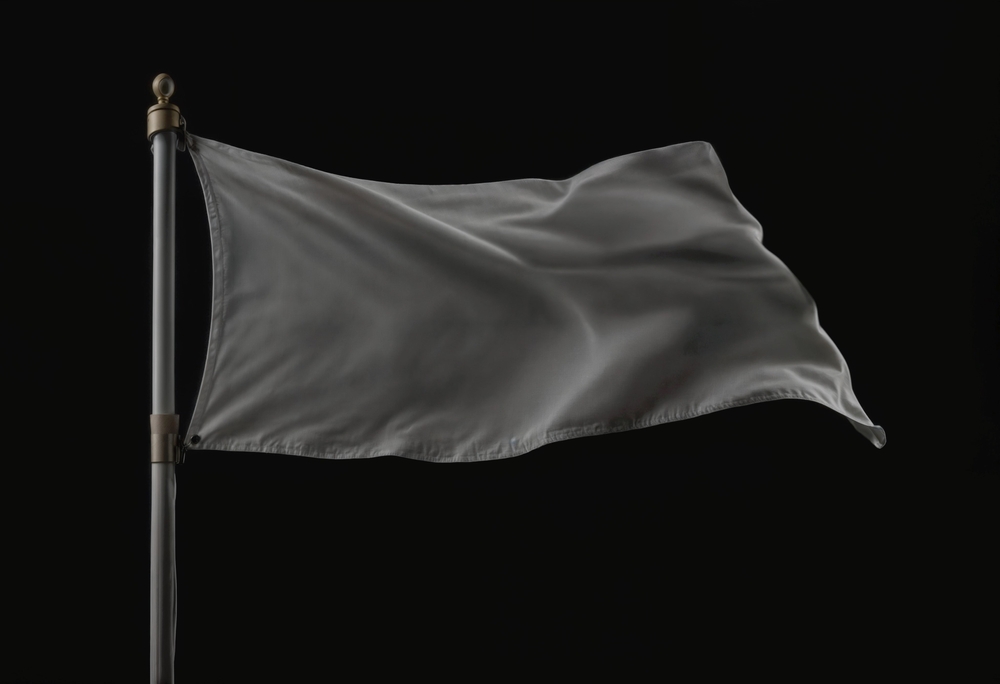 A,White,Flag,Waves,In,The,Wind,On,A,Flagpole