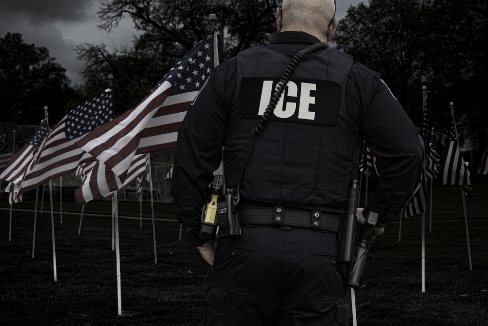 An,Immigration,(ice),Officer,Stands,In,Front,Of,Rows,Of