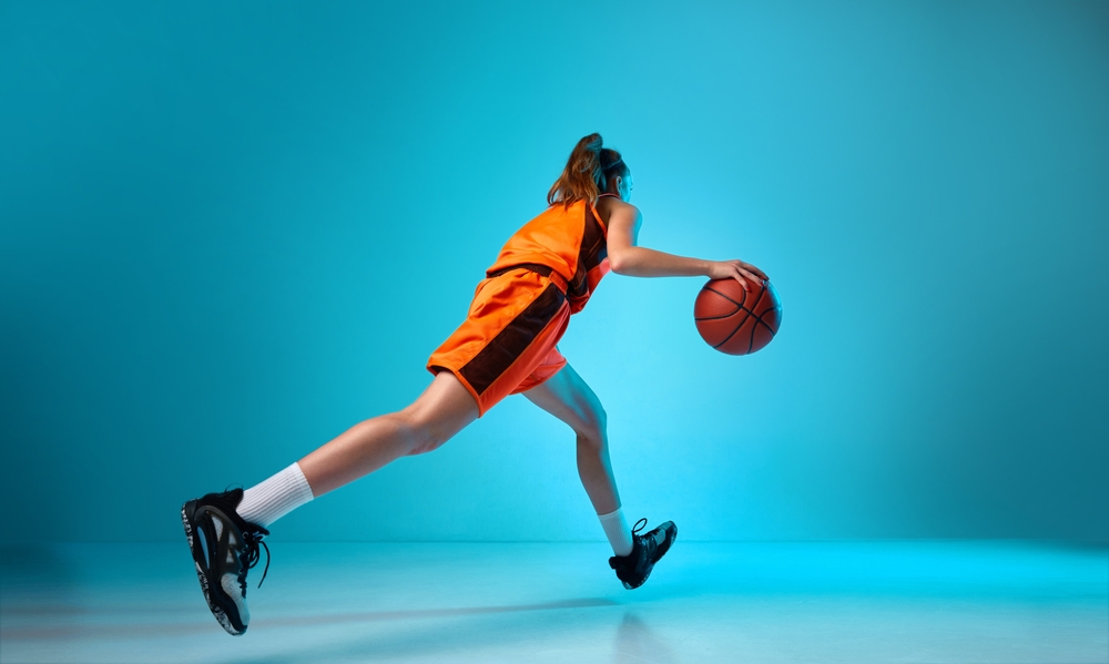 Back,View,Dynamic,Image,Of,Young,Girl,,Basketball,Player,Dribbling