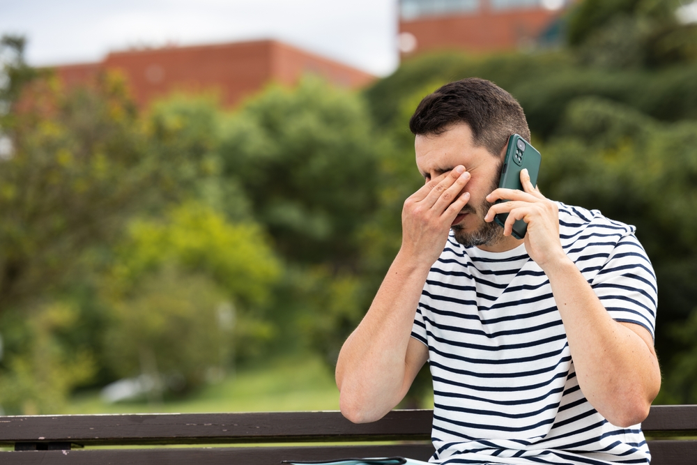 Sad,Young,Man,Receives,Bad,News,On,The,Phone,Sitting