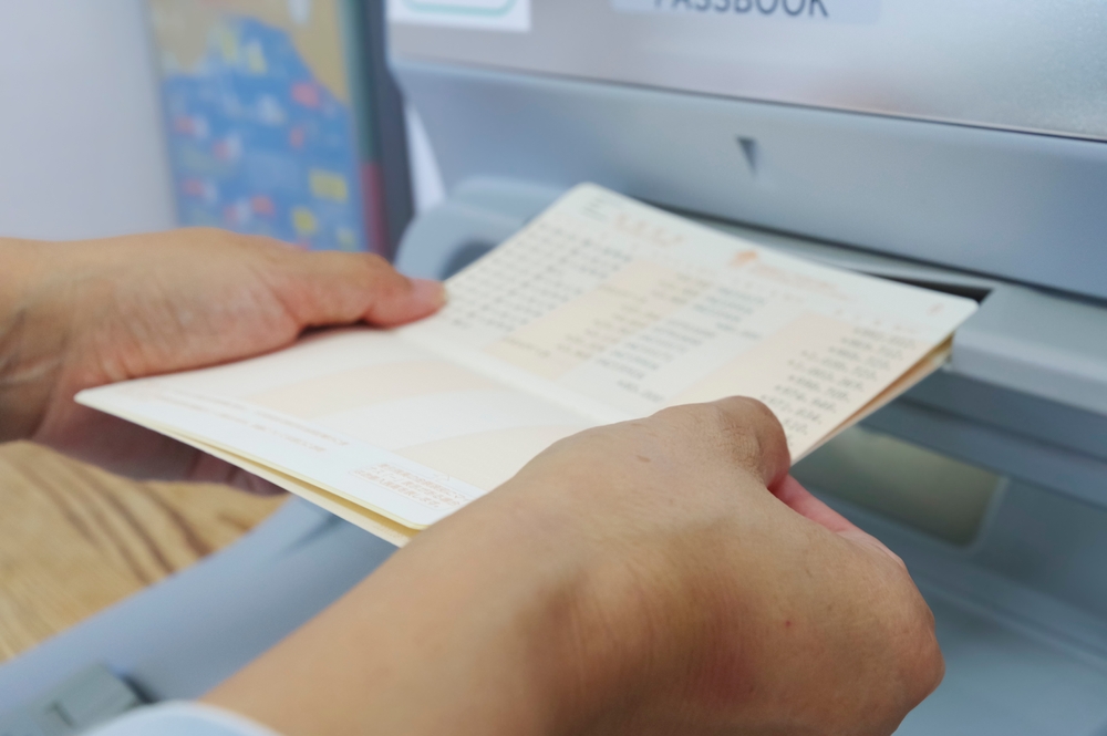 A,Woman,Withdrawing,Savings,At,An,Atm,”borrowing,Interest”,Is