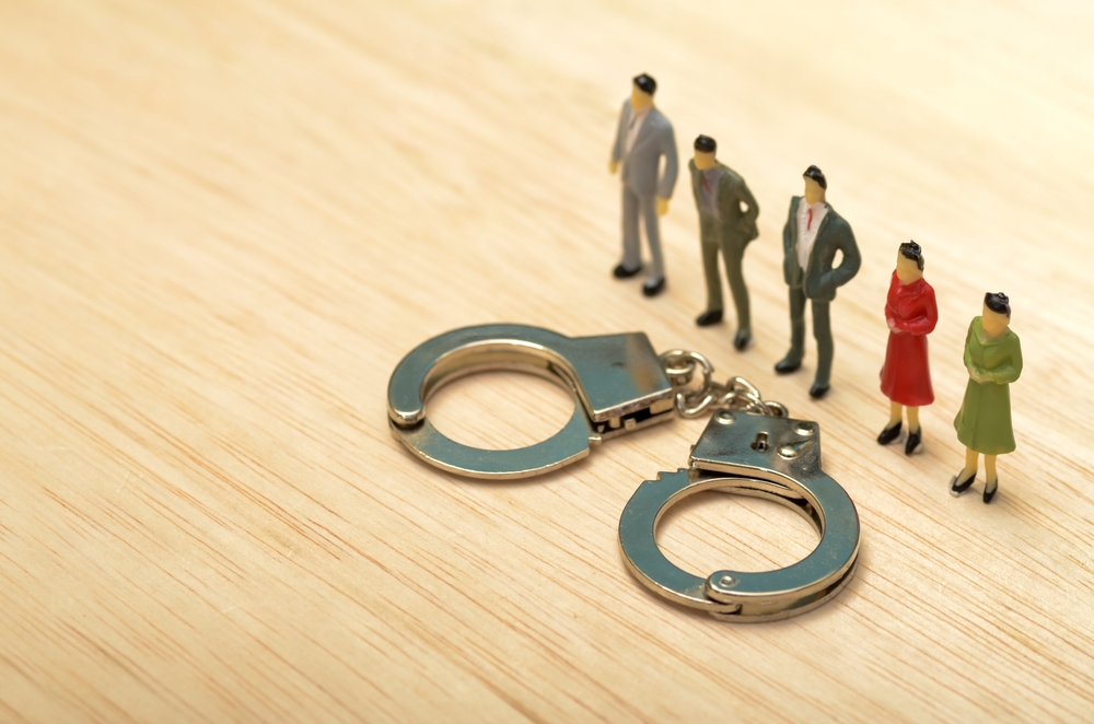 Businessmen,In,Row,With,Handcuffs:,Corporate,Dilemma,And,Legal,Consequences