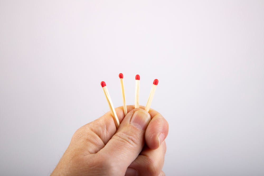 Four,Match,Sticks,In,A,Hand,,One,Is,Shorter,,As